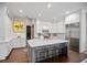 Spacious kitchen with white cabinets, marble countertops, and a central island with seating at 420 Greenridge Ct, Debary, FL 32713