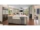 Open kitchen design with stainless steel appliances, a farmhouse sink, and an eat-in bar area at 420 Greenridge Ct, Debary, FL 32713