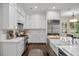 Well-appointed kitchen with white cabinets, marble countertops, and stainless steel appliances at 420 Greenridge Ct, Debary, FL 32713