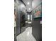 Modern laundry room with stackable washer/dryer, marble floors, and stylish cabinets at 420 Greenridge Ct, Debary, FL 32713