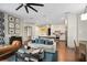 Open living room area flowing into a modern kitchen with white cabinets and stainless steel appliances at 420 Greenridge Ct, Debary, FL 32713