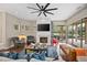 Spacious living room with a fireplace, large windows, and an open concept design at 420 Greenridge Ct, Debary, FL 32713