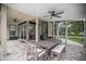 Covered patio area with dining table, chairs, and a built-in grill perfect for outdoor entertaining at 420 Greenridge Ct, Debary, FL 32713