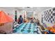 Spacious playroom with colorful rug, toys, built-in shelving and a reading nook at 420 Greenridge Ct, Debary, FL 32713