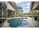 Inviting backyard oasis featuring a sparkling pool, comfortable lounge chairs, and a screened enclosure at 420 Greenridge Ct, Debary, FL 32713