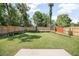 Large backyard featuring a lush lawn surrounded by a wooden privacy fence at 429 W Carolina Ave, Deland, FL 32720