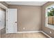 Cozy bedroom with neutral walls, hardwood floors, white trim, and window with backyard view at 429 W Carolina Ave, Deland, FL 32720