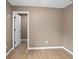 Light filled bedroom with light colored walls, hardwood floors and an opening to another room at 429 W Carolina Ave, Deland, FL 32720