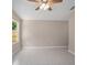 An airy bedroom with tile flooring, a modern ceiling fan, and a window letting in natural light at 429 W Carolina Ave, Deland, FL 32720