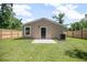 View of the back of the property, complete with a fenced yard and green space at 429 W Carolina Ave, Deland, FL 32720