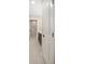 Hallway leading to a bathroom featuring a dark wood vanity and marble-walled shower at 429 W Carolina Ave, Deland, FL 32720