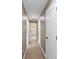 Hallway view with hardwood flooring, white trim, and paneled doors, with multiple rooms leading off at 429 W Carolina Ave, Deland, FL 32720