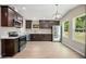 Modern kitchen features stainless steel appliances, dark wood cabinetry, and hardwood floors at 429 W Carolina Ave, Deland, FL 32720