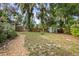 Expansive backyard featuring mature trees, a privacy fence, and a storage shed at 431 S Stone St, Deland, FL 32720