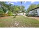 Well-sized backyard with a privacy fence, a wood deck, and mature shade trees at 431 S Stone St, Deland, FL 32720