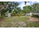 Large backyard with mature trees, a storage shed, and a wood deck at 431 S Stone St, Deland, FL 32720