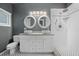Modern bathroom features dual sinks, a white vanity, and sleek tile at 431 S Stone St, Deland, FL 32720