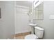 All-white bathroom with tiled walk-in shower, pedestal sink, and standard toilet at 431 S Stone St, Deland, FL 32720