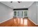 Bright bedroom with hardwood floors, gray walls, and French doors to a balcony at 431 S Stone St, Deland, FL 32720