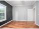 A spacious bedroom features beautiful hardwood floors and a large window for natural light at 431 S Stone St, Deland, FL 32720