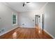 Bright bedroom with hardwood floors and a door that leads to another area of the house at 431 S Stone St, Deland, FL 32720