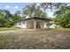 Charming white single-story home featuring a convenient carport and an additional detached building at 431 S Stone St, Deland, FL 32720