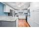 Bright kitchen with granite countertops, stainless steel appliances, and a central island at 431 S Stone St, Deland, FL 32720