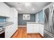 Modern kitchen with white cabinetry, granite countertops, and stainless steel appliances at 431 S Stone St, Deland, FL 32720