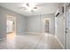 Bright living room features tile floors, a ceiling fan, and an efficient mini-split system at 431 S Stone St, Deland, FL 32720