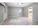A welcoming living room features tile floors and seamless access to the kitchen at 431 S Stone St, Deland, FL 32720