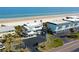 Aerial view of a beachfront property, buildings, and parking with beach access at 4786 S Atlantic Ave # 3, Ponce Inlet, FL 32127