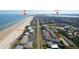 An aerial view of the beachfront property showing beach access, inlet, lighthouse, and parking at 4786 S Atlantic Ave # 3, Ponce Inlet, FL 32127
