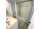 Clean bathroom with shower and tub combination, modern fixtures, and gray accents at 4786 S Atlantic Ave # 3, Ponce Inlet, FL 32127