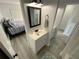 Well-lit bathroom leading to the bedroom with a vanity and modern fixtures at 4786 S Atlantic Ave # 3, Ponce Inlet, FL 32127