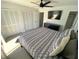 Bedroom boasting spacious closets, sleek dresser, ceiling fan, and mounted television at 4786 S Atlantic Ave # 3, Ponce Inlet, FL 32127