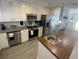 A spacious kitchen with stainless steel appliances, granite countertops, and butcher block island at 4786 S Atlantic Ave # 3, Ponce Inlet, FL 32127