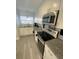 Updated kitchen featuring stainless steel appliances, granite countertops, and modern fixtures at 4786 S Atlantic Ave # 3, Ponce Inlet, FL 32127