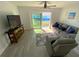 Cozy living area with natural light, comfortable seating, and sliding door access at 4786 S Atlantic Ave # 3, Ponce Inlet, FL 32127