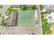 An aerial view of a tennis court located in a community with mature landscaping and a pool at 511 Polaris Loop # 105, Casselberry, FL 32707