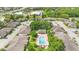Aerial view of the community featuring a pool and clubhouse area with lush landscaping at 511 Polaris Loop # 105, Casselberry, FL 32707