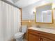Cozy bathroom features a tiled shower with curtain, vanity, and framed mirror at 511 Polaris Loop # 105, Casselberry, FL 32707