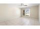 Bright bedroom features tile flooring, a ceiling fan, and a window with neighborhood view at 511 Polaris Loop # 105, Casselberry, FL 32707