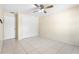 Neutral bedroom has tile flooring, a ceiling fan, closet, and neutral paint at 511 Polaris Loop # 105, Casselberry, FL 32707