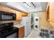 Well-equipped kitchen adjacent to a laundry nook with stacked washer and dryer units at 511 Polaris Loop # 105, Casselberry, FL 32707