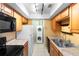 Well-equipped kitchen adjacent to a laundry nook with stacked washer and dryer units at 511 Polaris Loop # 105, Casselberry, FL 32707