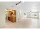 Open-concept living room with tile floors leads into an adjacent kitchen with light wood cabinetry at 511 Polaris Loop # 105, Casselberry, FL 32707
