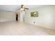 Open-concept living area featuring tile flooring and a view into the kitchen at 511 Polaris Loop # 105, Casselberry, FL 32707