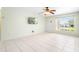 Bright living room features tile floors, a ceiling fan, and a window for ample natural light at 511 Polaris Loop # 105, Casselberry, FL 32707