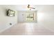 Bright living room features tile floors, a ceiling fan, and a window for ample natural light at 511 Polaris Loop # 105, Casselberry, FL 32707