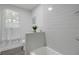 Modern bathroom featuring white subway tile, sleek fixtures, and a bright window at 528 Pine St, Daytona Beach, FL 32114